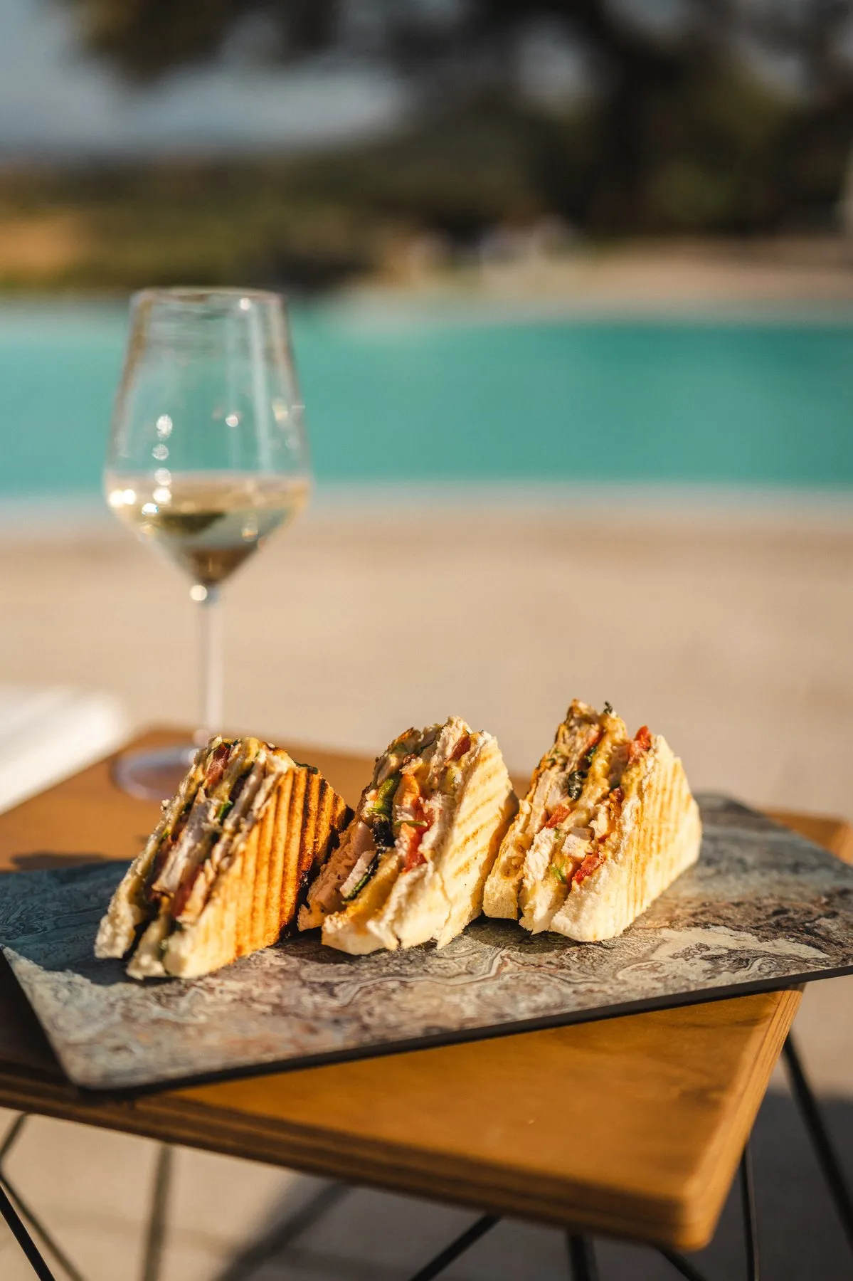 Lumina Club Sandwich with a glass of wine